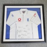 An Ashes 2005 cricket shirt, signed by various players, in a display frame,