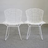 A pair of Harry Bertoia style white painted wire chairs