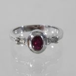 An 18 carat gold ruby and diamond dress ring, boxed,