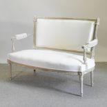 A French style cream upholstered and painted sofa,