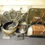 A collection of brass items, to include a peacock fire screen, another screen, circular chargers,