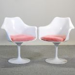 A pair of 1970's style white moulded plastic swivel chairs, after the Eero Saarinen tulip design,