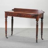 A Victorian mahogany side table, containing a pair of short drawers, on turned legs,