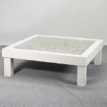 A cream painted coffee table, with an inset glass top,