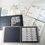 A stamp album, together with three others, and a folder,