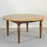 A Mark Elliot oak circular dining table, on turned legs, 144cm diameter,