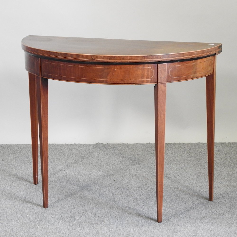 A Regency mahogany and crossbanded D shape folding card table,