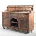 An early 20th century oak dresser base, with a gallery back,