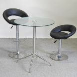 A chrome bar table with a circular glass top, 75cm diameter,