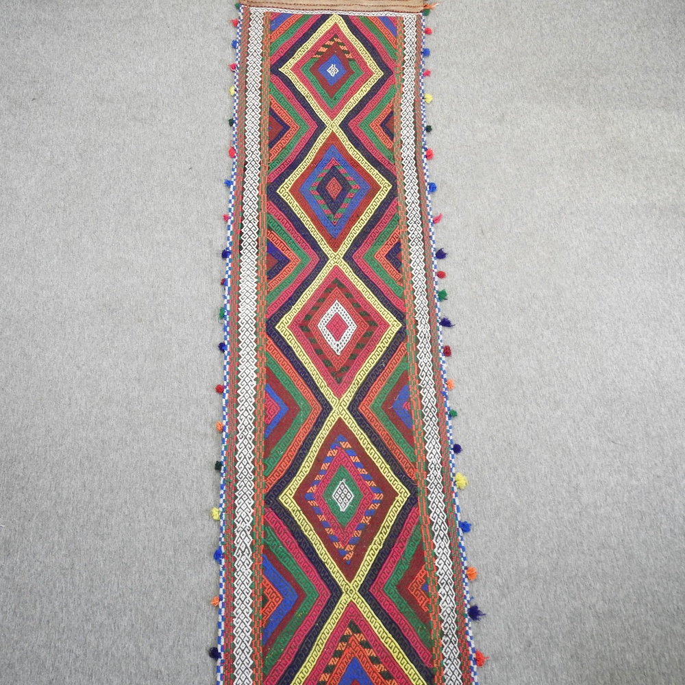 A kelim runner, with five central medallions,