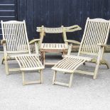 A pair of teak folding garden steamer chairs, together with a folding garden table,