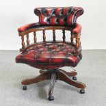 A red upholstered swivel desk chair,