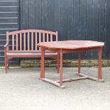 A wooden octagonal extending garden table, 175 x 105cm overall, together with a garden bench,