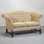 A gold upholstered button back sofa,