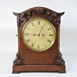 A 19th century carved oak cased bracket clock, with a double fusee movement,