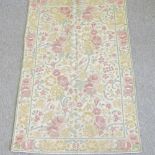An Indian crewel work rug, with all over floral designs,