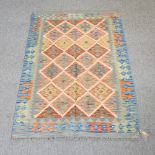 A kelim rug, with diamond pattern, on a blue ground,