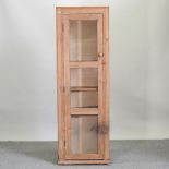 A pine glazed side cabinet,