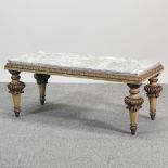 A carved cream and gilt painted marble top coffee table,