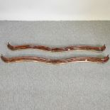 A pair of 19th century French simulated walnut and brass mounted double serpentine curtain pelmets,