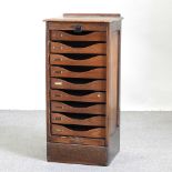 An early 20th century oak tambour front filing cabinet,