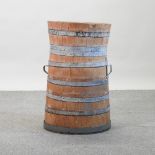 An antique coopered wooden barrel, converted to a stick stand,