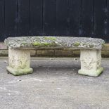 A reconstituted stone curved garden bench,