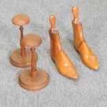 A pair of early 20th century turned wooden wig stands,