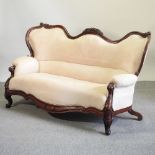 A Victorian carved mahogany show frame sofa,