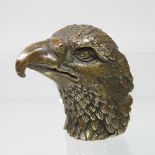 A bronze paperweight, in the form of an eagle head,