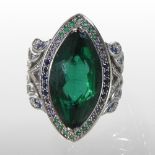 A large St Diamond 18 carat gold ring, the central green facet cut elliptical stone,