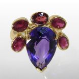 A large designer 18 carat gold, tanzanite and ruby cluster ring, the central tear shaped stone,