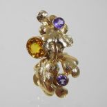 A large unmarked quartz and tanzanite ring, in the form of twisted leaves,