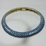 A Ciner gilt and coloured enamelled flexible choker necklace, of snakeskin design in blue and green,