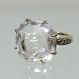 A large 18 carat gold clear quartz and diamond ring, the central cushion cut stone, 15mm,