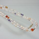 An unusually long single strand cultured pearl, coloured bead and gilt bead necklace,