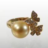 A contemporary 18 carat gold, pearl and diamond designer ring,