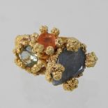 A silver gilt dress ring, in the form of coral, set with three variously cut gemstones,