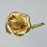 A French G R Lecomte unmarked brooch, in the form of a rose, set with a diamond, 4cm long, 10.