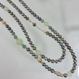 A JKa pearl and jade coloured long single strand bead necklace,