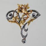 An 18 carat gold and platinum set diamond brooch, of scrolled foliate asymmetrical design,