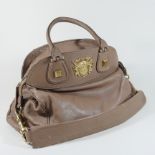 A Givenchy tan leather shoulder bag, decorated with a gilt crest,