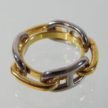 An Hermes unmarked two colour scarf ring, in the form of interlocking chain links,