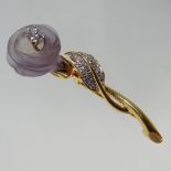 An 18 carat gold, diamond and pink opaque glass articulated brooch, in the form of a flower,