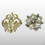 An unmarked diamond and enamelled brooch, set with a single stone, above a pair of enamelled reeds,