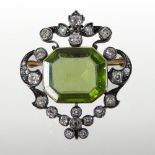 An unmarked peridot and diamond brooch,