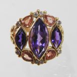 An unmarked diamond, tanzanite and gem set ring, set with three central elliptical stones,