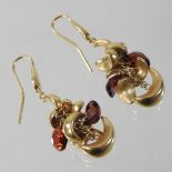 A pair of 18 carat gold and garnet set pendant cluster earrings, 5cm drop, 14.