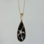 A Kabana 14 carat gold, diamond and black onyx necklace, suspended with a fan decorated pendant,