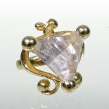 A modern 18 carat gold and quartz set ring, set with a large triangular pink stone,